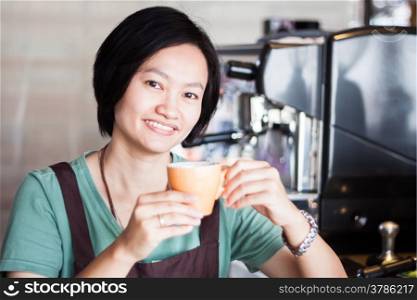Asian barista enjoy her coffee, stock photo
