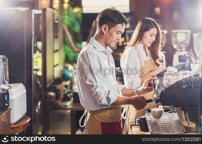 Asian Barista preparing cup of coffee, espresso with latte or cappuccino for customer order in coffee shop,making espresso, Small business owner and startup in coffee shop and restaurant concept