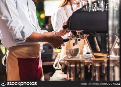 Asian Barista preparing cup of coffee, espresso with latte or cappuccino for customer order in coffee shop,making espresso, Small business owner and startup in coffee shop and restaurant concept