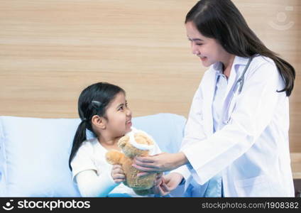 Asian beautiful doctor is smiling and check up patient, a girl who got a cast on her arm because of accident. Health, Hospital and Insurance Concept.