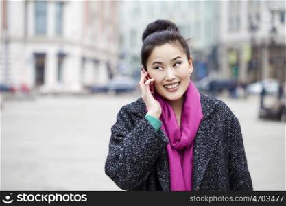 Asian beautiful girl calling by phone in spring street