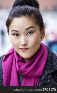 Asian beautiful woman in stylish gray coat on a background of spring street