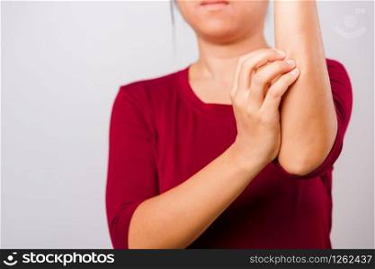 Asian beautiful woman itching her scratching her itchy arm on white background with copy space, Medical and Healthcare concept
