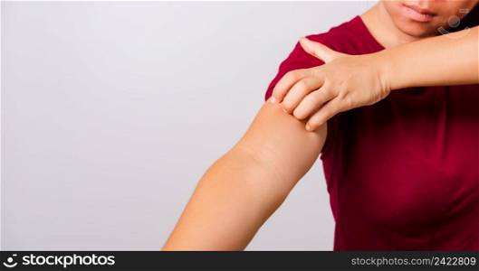 Asian beautiful woman itching her scratching her itchy arm on white background with copy space, Medical and Healthcare concept