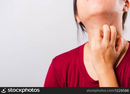 Asian beautiful woman itching her scratching her itchy neck on white background with copy space, Medical and Healthcare concept