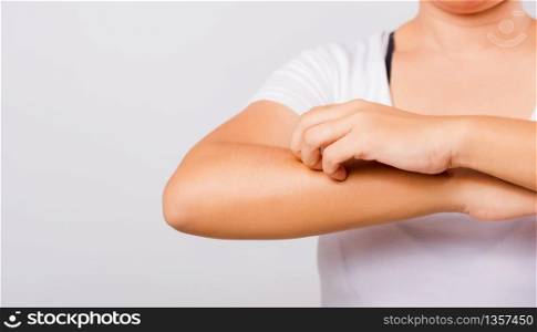 Asian beautiful woman itching her useing hand scratch itch Arm on white background with copy space, Medical and Healthcare concept