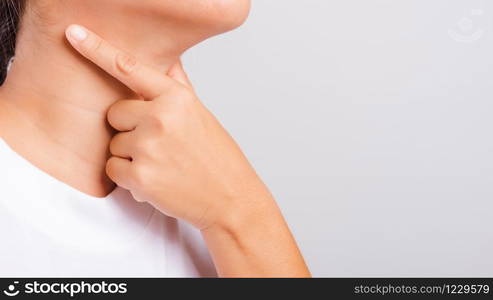 Asian beautiful woman Sore Throat or thyroid gland problem her useing Hand Touching Ill Neck on white background with copy space, Medical and Healthcare concept