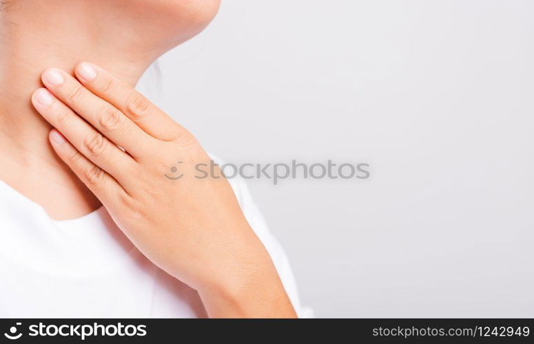 Asian beautiful woman Sore Throat or thyroid gland problem her useing Hand Touching Ill Neck on white background with copy space, Medical and Healthcare concept