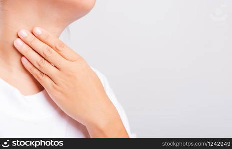 Asian beautiful woman Sore Throat or thyroid gland problem her useing Hand Touching Ill Neck on white background with copy space, Medical and Healthcare concept