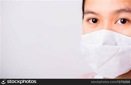 Asian beautiful woman wearing protection face mask against coronavirus her looking to camera, studio shot isolated on white background with copy space, COVID-19 or corona virus concept