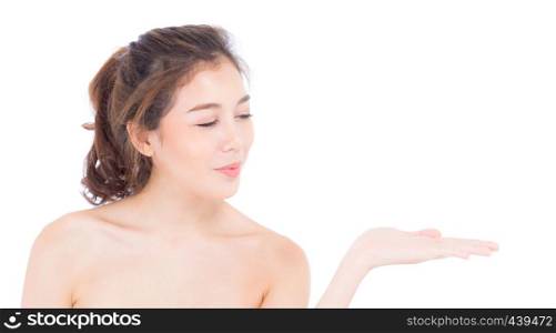 Asian beautiful young woman showing with healthy clean skin presenting something empty copy space on the hand isolated on white background, beauty concept.