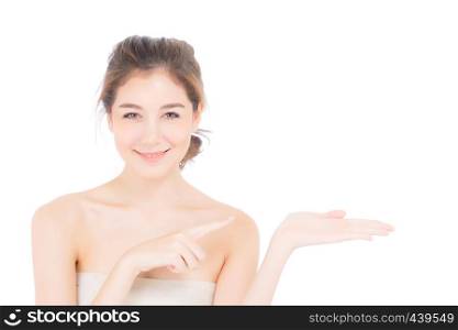 Asian beautiful young woman showing with healthy clean skin presenting something empty copy space on the hand isolated on white background, beauty concept.