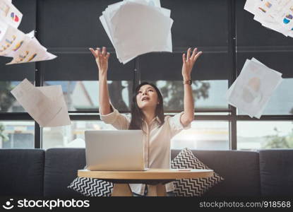 Asian beauty businesswoman throwing paperwork into the air. Successful and achievement concept. Business and Occupation concept. Freelance and business owner theme.