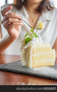 Asian beauty Scooping the cake to eat In Caffe Holiday idea Eating sweets, the cause of obesity, weight gain, poor health