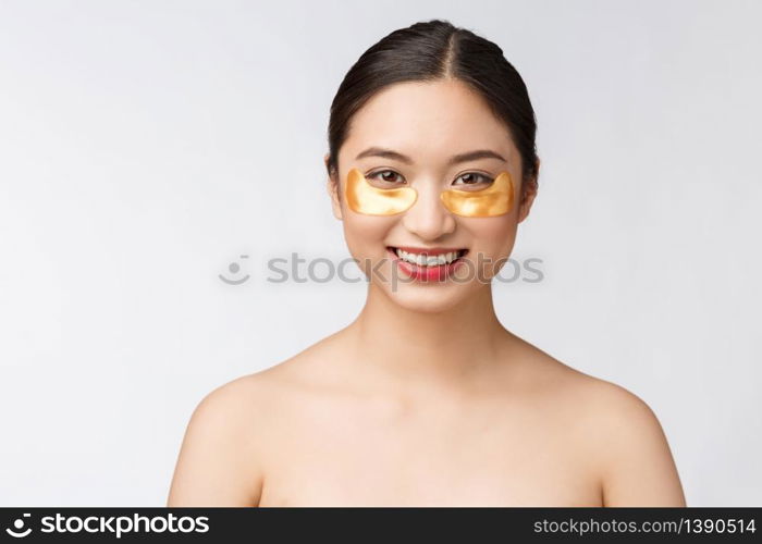 Asian beauty teenager woman care her skin with gold eye masks patches under eyes.. Asian beauty teenager woman care her skin with gold eye masks patches under eyes