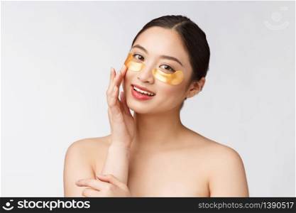 Asian beauty teenager woman care her skin with gold eye masks patches under eyes.. Asian beauty teenager woman care her skin with gold eye masks patches under eyes