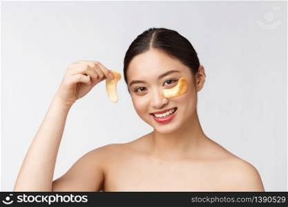 Asian beauty teenager woman care her skin with gold eye masks patches under eyes.. Asian beauty teenager woman care her skin with gold eye masks patches under eyes