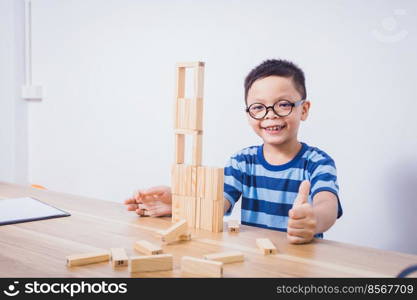 Asian boy playing with a wooden puzzle