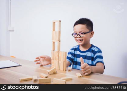 Asian boy playing with a wooden puzzle