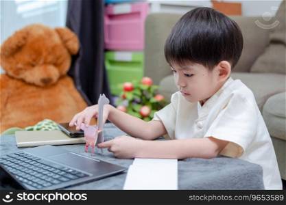 Asian boy studying online on laptop and learning from paper animals