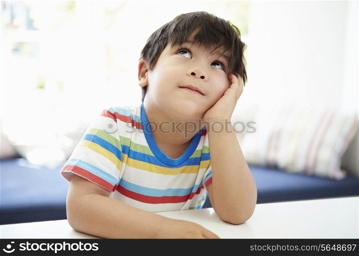 Asian Boy With Head In Hands Thinking