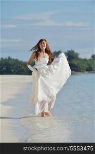 asian bride with a veil on the beach in the sky and blue sea. honeymoon on the fantastic island at summer