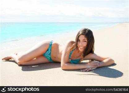 Asian brunette girl lying on the beach white sand in summer vacation