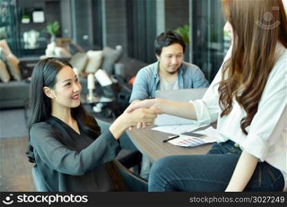 Asian business Colleagues shaking hands in office
