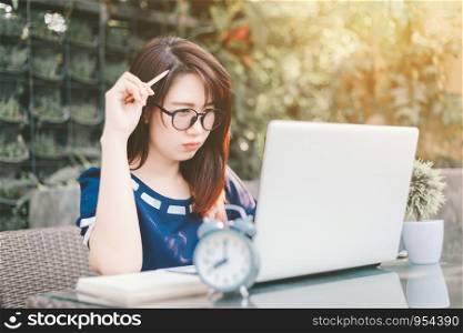 Asian business female working with laptop on office outdoor,Think about the job.