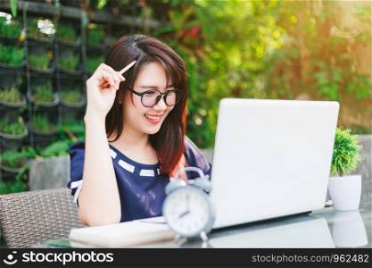 Asian business female working with laptop on office outdoor,Think about the job.