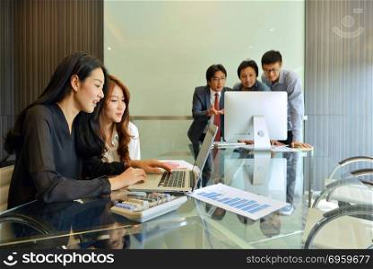 Asian business people discussing with each other