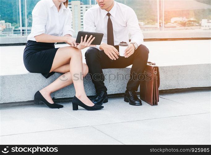 Asian business people meeting and using digital tablet outdoor after work