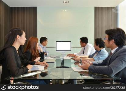 Asian Business team meeting in front of a computer with blank screen, mock up. Asian Business team meeting in front of a computer with blank sc