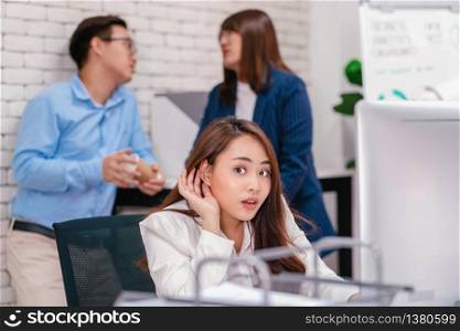 Asian Business woman be curious and listening the couple talking about lovers problem while working hour at modern office, gossip and secret, eavesdrop and whisper, relationship in office concept