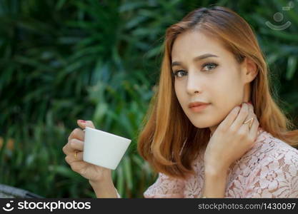 Asian business woman drinking coffee and business women smiling happy for working