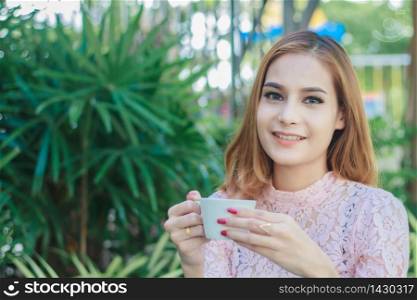 Asian business woman is working and drinking coffee on outdoor