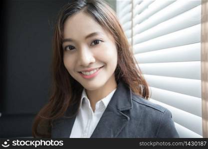 Asian business woman smiling and happy for working in the office