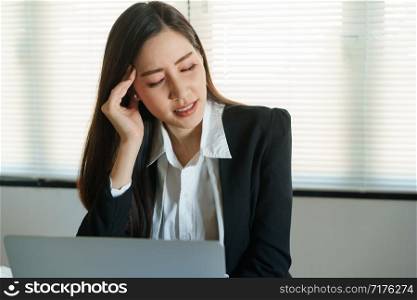 Asian business woman stressful working with a computer for a long time, Office syndrome concept