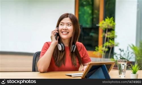 Asian business woman using mobile phone with keyboard and calling for working from home in outdoor home and garden, startups and business owner, social distance and self responsibility