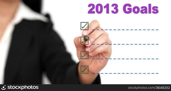 Asian business woman writing 2013 Goal List