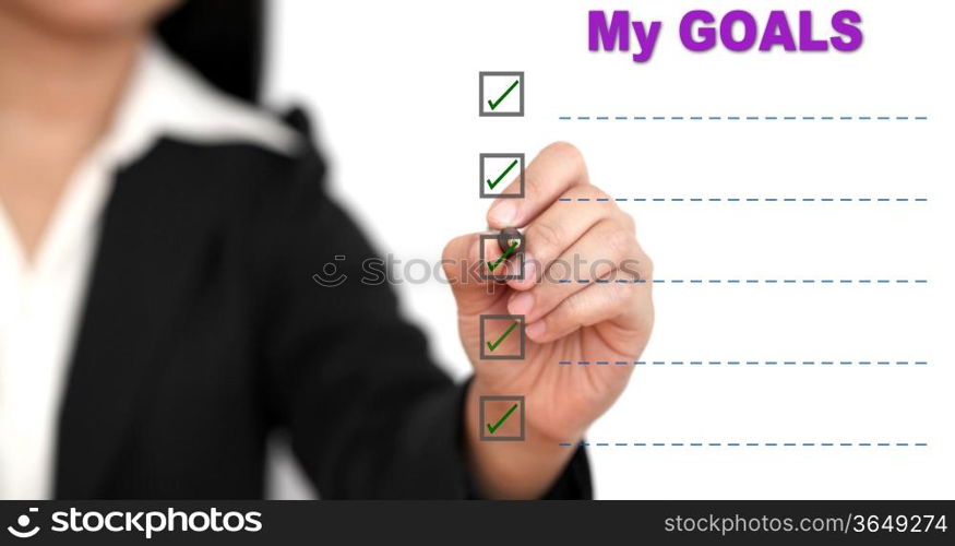 Asian business woman writing goal list on white board