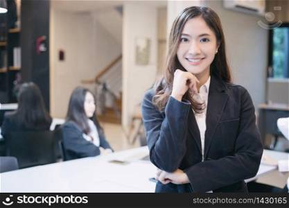 Asian business women and group using notebook for meeting and business women smiling happy for working