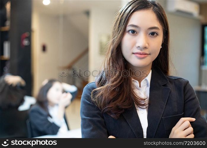 Asian business women and group using notebook for meeting and business women smiling happy for working