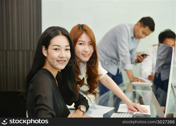 Asian Business women smiling in meeting room