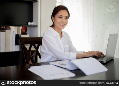 Asian business women using notebook and smiling happy for working