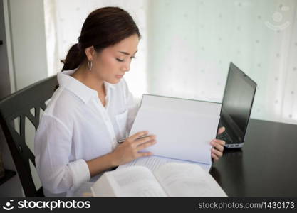 Asian business women using notebook and smiling happy for working