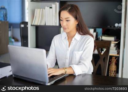 Asian business women using notebook and smiling happy for working