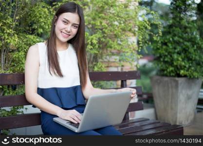 Asian business women using notebook and smiling happy for working at outdoor