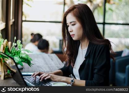 Asian business women using notebook for working