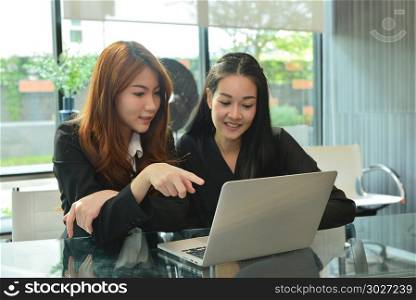 Asian business women working and using laptop in meeting room